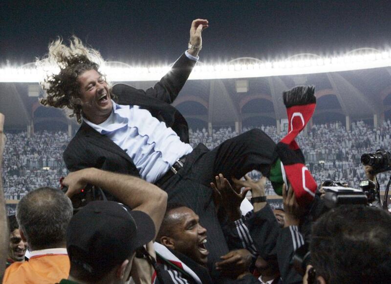 Members of the United Arab Emirates team throw their French coach Bruno Metsu into the air as they celebrate after beating Oman during the final of the 2007 Gulf Cup in Abu Dhabi. Fadi Al Assaad / Reuters