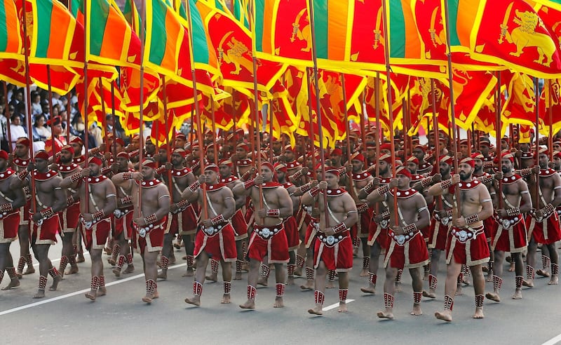 Sri Lanka's military members march with national flags in the parade during Sri Lanka's 71st Independence day celebrations in Colombo. Reuters