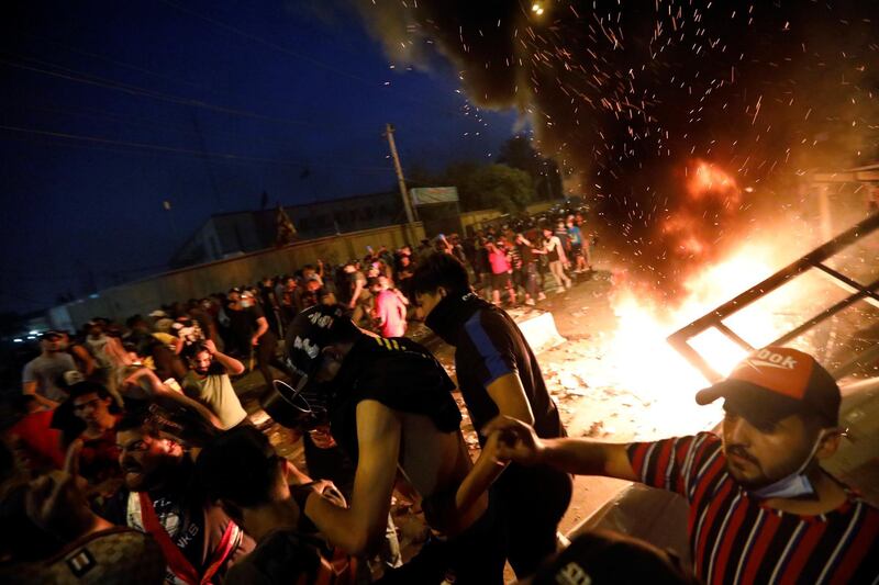 Demonstrators gather at a protest during a curfew. Reuters