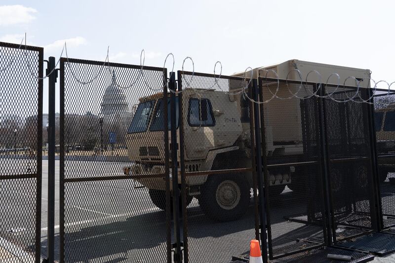 An armoured truck and barbed wire fence serve as a part of a large security perimeter around the US Capitol building. Willy Lowry / The National