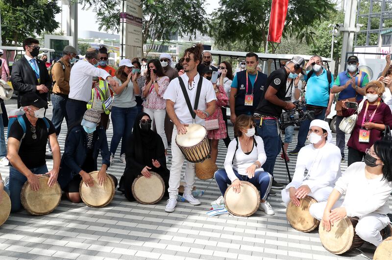 Artists play drums with visitors during the Israel day celebration.