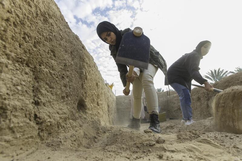 Sara Al Hameli, left, and Mai Al Mansouri Zayed University students interning with the Abu Dhabi Tourism & Culture Authority, TCA, excavate a portion of the Bayt Bin Hadi archeological site in the Hili Oasis area of Al Ain. Christopher Pike / The National