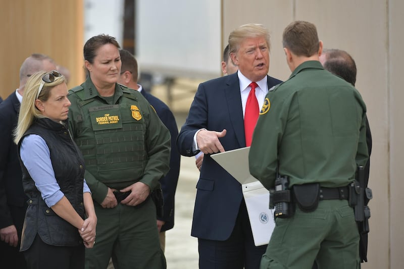 US President Donald Trump is shown border wall prototypes in San Diego, California on March 13, 2018. / AFP PHOTO / MANDEL NGAN
