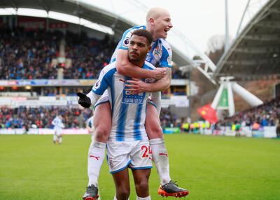 Soccer Football - Premier League - Huddersfield Town vs AFC Bournemouth - John Smith’s Stadium, Huddersfield, Britain - February 11, 2018   Huddersfield Town’s Steve Mounie celebrates scoring their third goal with Aaron Mooy    Action Images via Reuters/Jason Cairnduff    EDITORIAL USE ONLY. No use with unauthorized audio, video, data, fixture lists, club/league logos or "live" services. Online in-match use limited to 75 images, no video emulation. No use in betting, games or single club/league/player publications.  Please contact your account representative for further details.