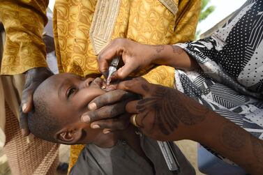 A health worker administers a vaccine during a campaign against polio in Hotoro-Kudu, in the Nassarawa district of Kano in north-west Nigeria, in 2017. AFP