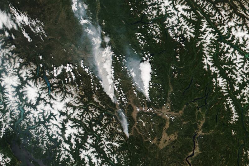 A handout satellite image made available by the National Aeronautics and Space Administration (NASA) shows the McKay Creek fire, left; the Sparks Lake fire, right; and smaller fire, visible just south of the town of Lytton, British Columbia.