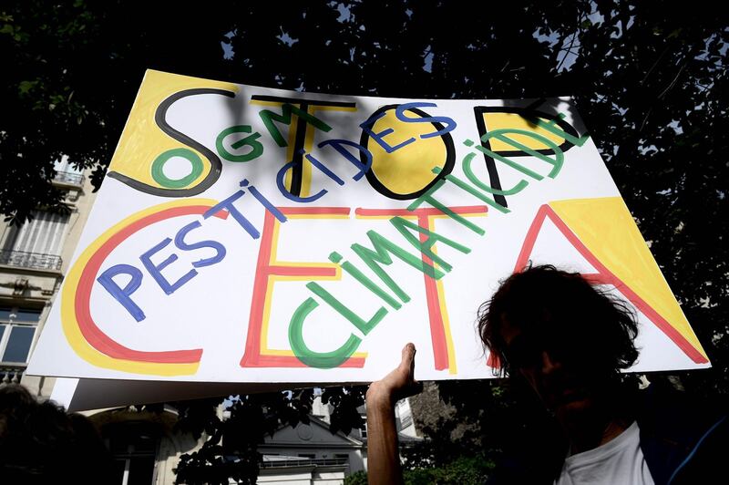 A man takes part in a demosntration against the Comprehensive Economic and Trade Agreement (CETA) in Paris on July 16, 2019. / AFP / PHILIPPE LOPEZ
