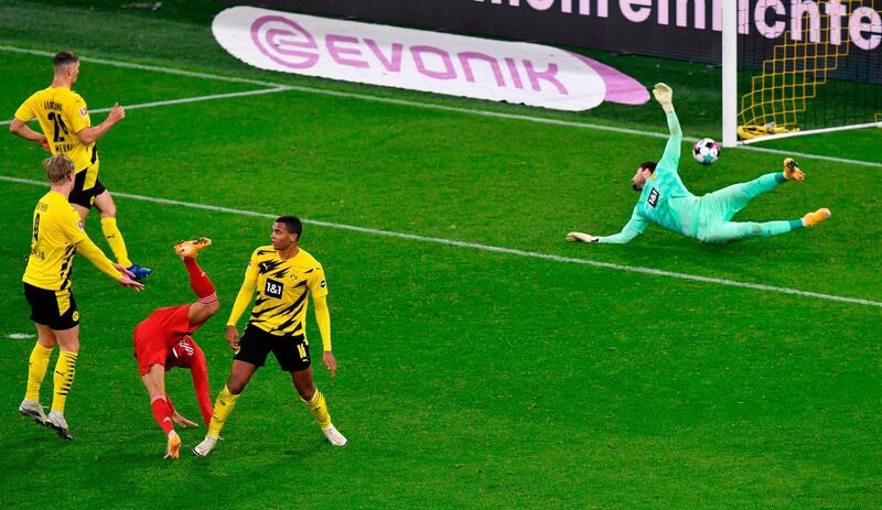 Bayern Munich's German midfielder Leroy Sane shoots past Dortmund Swiss goalkeeper Roman Buerki to make it 3-1. AFP