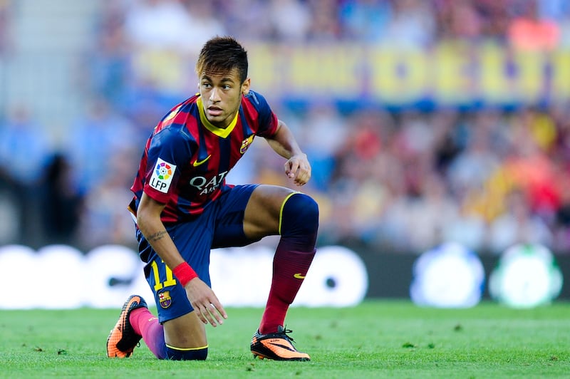 Neymar crouches down on the Camp Nou turf during his Barcelona debut against Levante in 2013. Getty