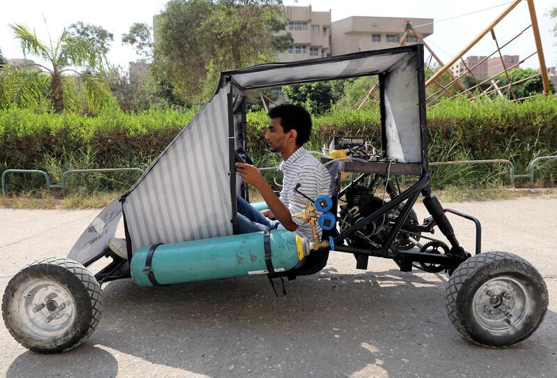 Mahmoud Yasser, mechanical engineering student from Helwan University, drives the air-powered vehicle in Cairo, Egypt. Reuters