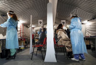 Healthcare workers take nasal swab samples from people, as they need to be tested to pass the barricade for the non-stop "Covid-free" direct train from Rome to Milan, as the outbreak of the coronavirus disease (COVID-19) continues, in Rome, Italy, April 16, 2021. REUTERS/Yara Nardi