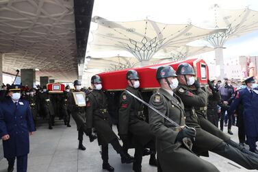 The coffins of three Turkish military members killed in Iraq are carried during funeral prayers at Ahmet Hamdi Akseki Mosque in Ankara on February 12, 2021. AFP