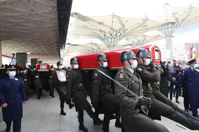 The coffins of three Turkish military personnel killed in action are carried during funeral prays at Ankara's Ahmet Hamdi Akseki Mosque in Ankara on February 12, 2021.  The three soldiers Lt. Burak Coskun, Lt. Ertug Guler and Sgt. First Class Harun Turhan were killed during clashes with Kurdish militants in northern Iraq's Gara region as part of the Eagle Claw 2 operation by the Turkish military against the outlawed Kurdistan Workers' Party (PKK).  / AFP / Adem ALTAN
