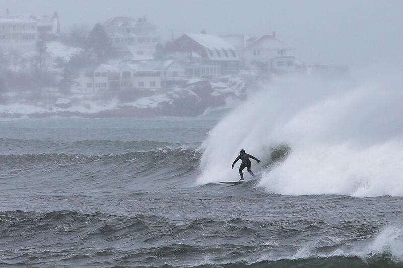 Surfers take advantage of wind and waves from a winter snow storm in Gloucester, Massachusetts. Brian Snyder / Reuters