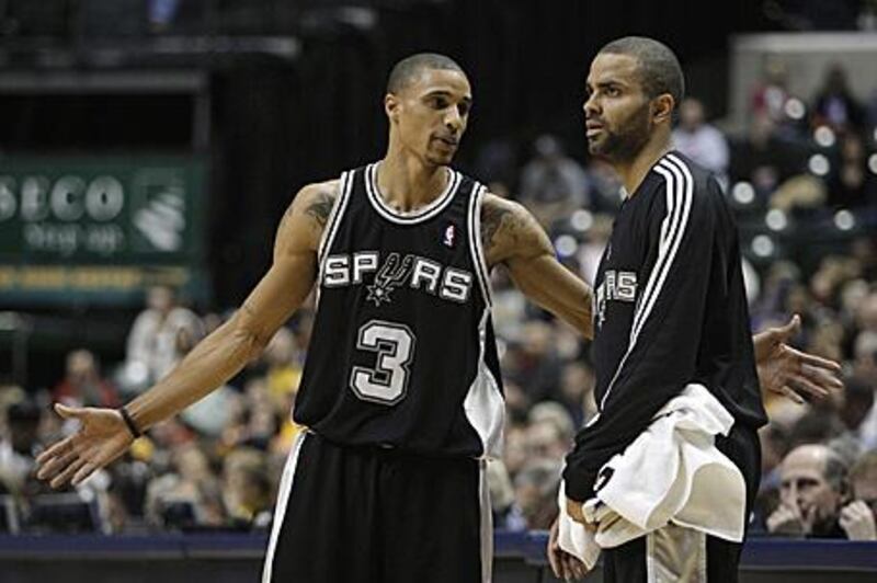 The sidelined Spurs point guard, Tony Parker, right, with his teammate George Hill during a break in the action.