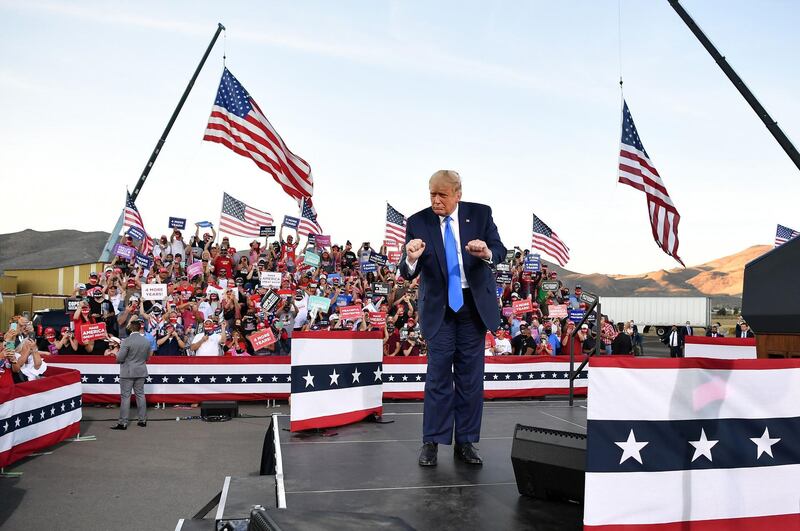 US President Donald Trump dances at the end of a rally at Carson City. AFP