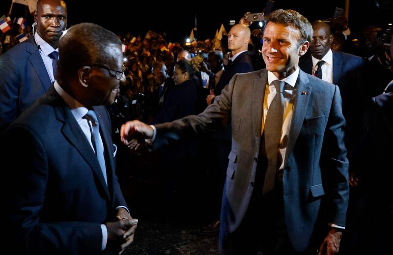 France's President Emmanuel Macron, right, arrives in Cameroon's capital Yaounde on July 25, where he is welcomed by Cameroon Prime Minister Joseph Dion Ngute. AFP