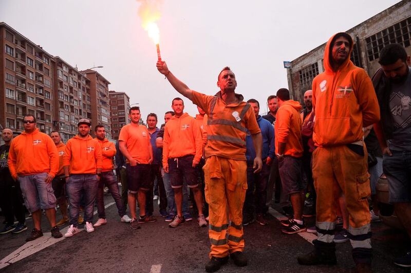 A port worker holds a flare at the beginning of a 48-hour strike at the Port of Bilbao, to protest the reform of operations, aimed at liberalising hiring practices, in Santurtzi, Spain. Vincent West / Reuters