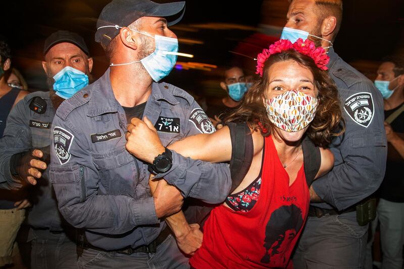 Israeli police officers arrest a demonstrator during a protest against Israel's Prime Minister Benjamin Netanyahu. AP