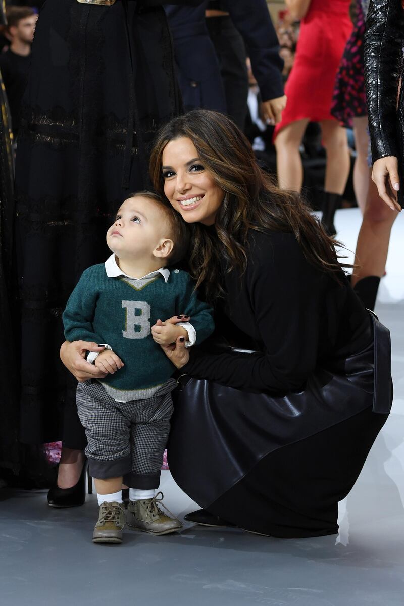 Eva Longoria and her son, Santiago, pose on the runway during the L'Oreal Paris show as part of Paris Fashion Week on September 28, 2019. Getty Images