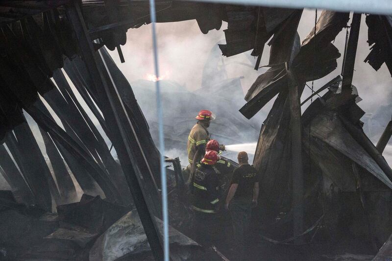 BEIRUT, LEBANON - SEPTEMBER 10: Firefighters walk through a burned out warehouse as they respond to a huge blaze at Beirut port on September 10, 2020 in Beirut, Lebanon. The fire broke out in a structure in the city's heavily damaged port facility, the site of last month's explosion that killed more than 190 people. (Photo by Sam Tarling/Getty Images)