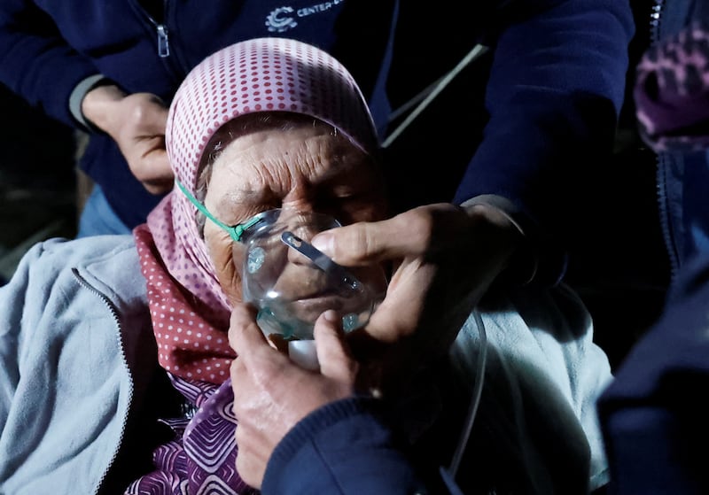 A woman is assisted after an earthquake in Antakya in Hatay province, Turkey.