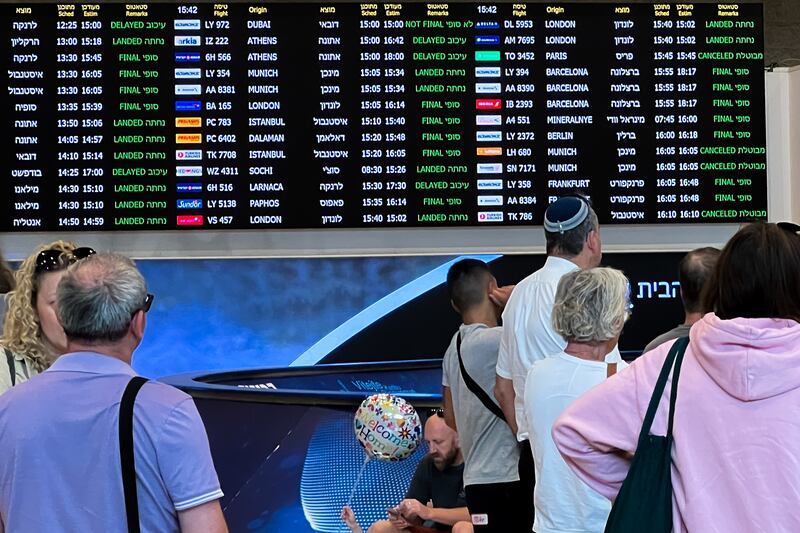 People view a sign showing landed and cancelled flights at the arrivals hall at Ben Gurion Airport in Lod, south-east of Tel Aviv. Getty Images