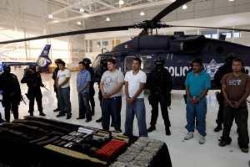 Federal police present alleged members of the Mexican drug cartel "La Familia Michoacana," detained in a recent police operation, as they are presented to the press in Mexico City, Thursday, Oct. 22, 2009.  Suspects from from left to right are Rogelio Rivera, Orlando Tafoya, Juan Estrada Rodriguez, Jose Roberto de la Sancha, Juan Gabriel Cortez and Julio Enrique Aguilar. (AP Photo/Gregory Bull) *** Local Caption ***  MXGB103_Mexico_Drug_War.jpg