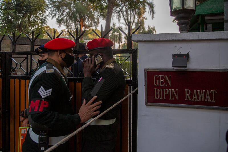 Military police personnel stand outside Gen Rawat's residence. AP Photo