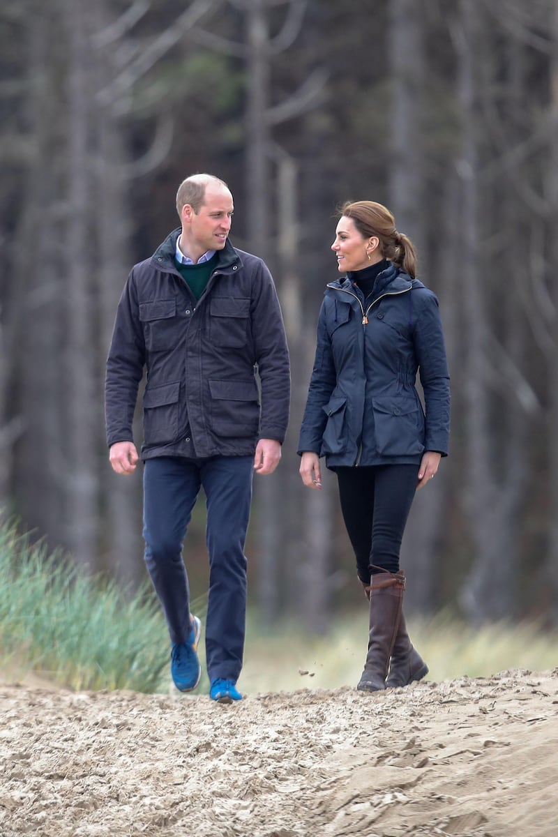 The Duchess of Cambridge wears a navy wax parka by Troy London over a Barbour Longshore Quilted Padded Jacket over a black polo neck and jeans, with Penelope Chilvers boots on a visit to Newborough Beach, North Wales on May 8. Getty Images
