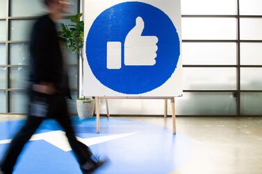 (FILES) In this file photo taken on October 23, 2019, a Facebook employee walks by a sign displaying the "like" sign at Facebook's corporate headquarters campus in Menlo Park, California.  - A former Facebook worker reportedly told US authorities October 22, 2021 the platform has put profits before stopping problematic content, weeks after another whistleblower helped stoke the firm's latest crisis with similar claims.  (Photo by Josh Edelson  /  AFP)