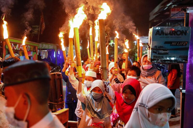 Muslim children carry torches around the neighbourhood during a parade to celebrate Eid al-Fitr, marking the end of the holy fasting month of Ramadan in Jakarta, Indonesia. Reuters
