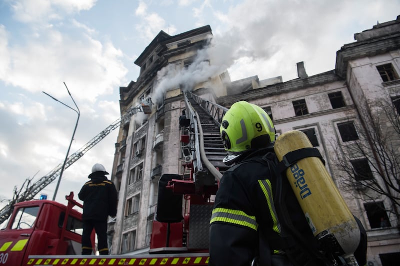 Ukrainian firefighters at the scene of a missile strike in Kyiv. EPA