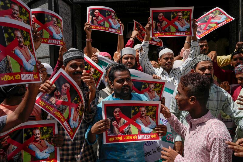 Muslims hold placards during a protest outside a mosque in Mumbai. AP 