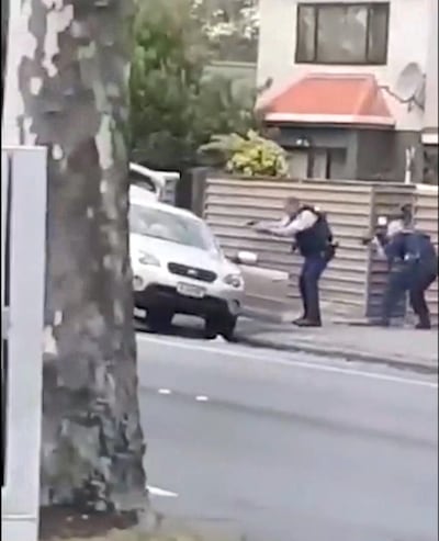 Social media video grab of police at the car of a suspect following shootings at two mosques in Christchurch