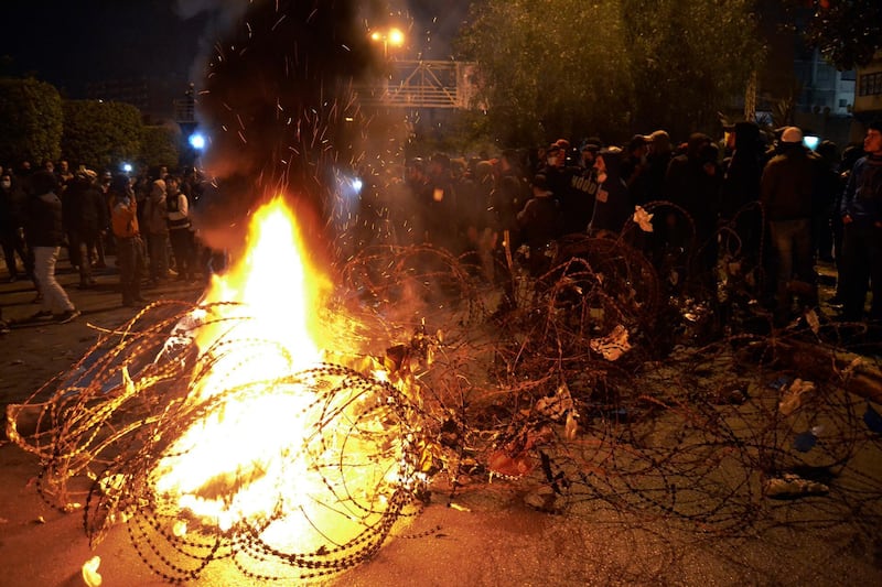 Lebanese protesters burn garbage and tires during a protest against strict lockdown measures in Tripoli, north Lebanon. AP