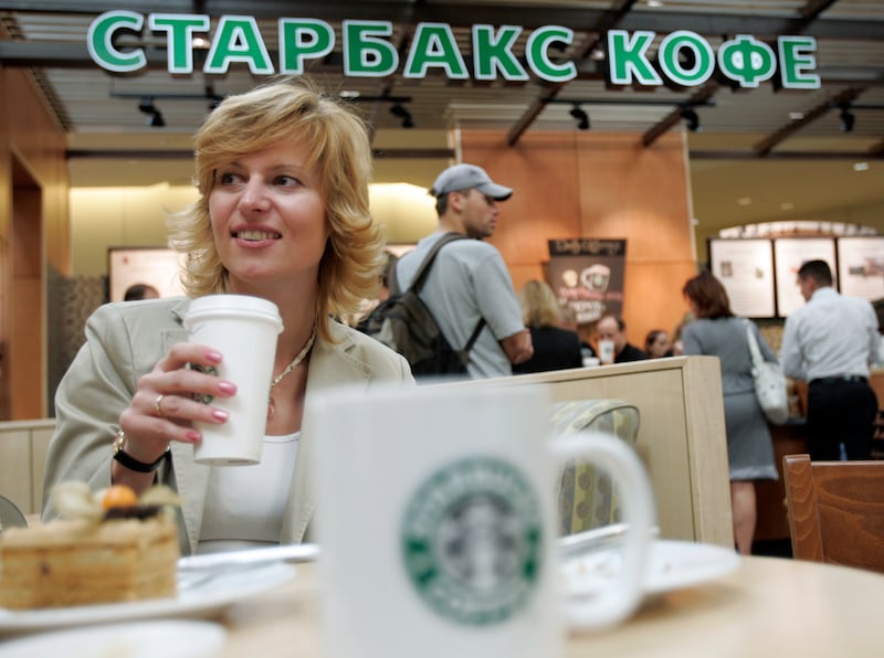 A woman drinks coffee inside a Starbucks cafe in Khimki in 2007. Reuters