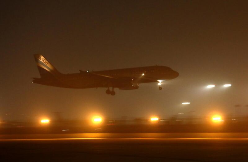 An Indigo plane lands amidst evening smog at the Delhi airport in New Delhi, India, Thursday, Oct. 31, 2019. Two days after Diwali festival, Delhi's air quality continued to hover between the 'very poor' and 'severe' category. (AP Photo/Manish Swarup)