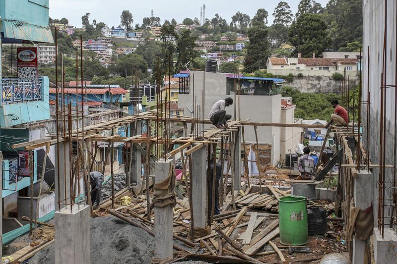 Workers labor at a construction site in Coonoor, Tamil Nadu, India, on Thursday, June 7, 2018. Most Asian markets were in the red on June 18 as concern that the row between U.S. and China may turn into a full-blown trade war. Most Asian markets were in the red on June 18 as concern that the row between U.S. and China may turn into a full-blown trade war. Photographer: Dhiraj Singh/Bloomberg