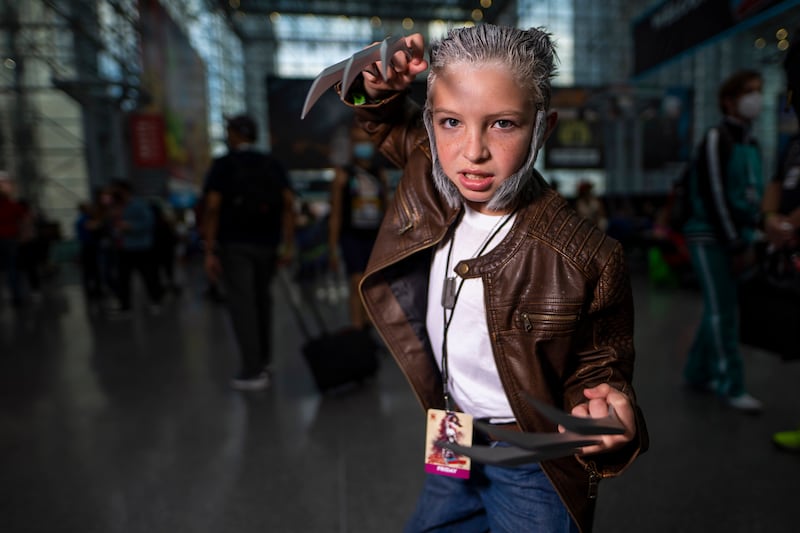 A young attendee dressed as Wolverine poses during New York Comic Con. Charles Sykes / Invision / AP