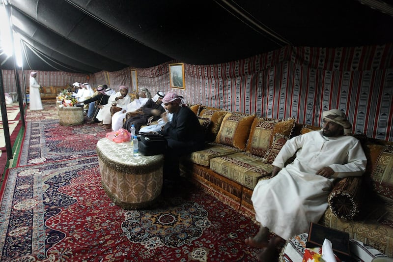 United Arab Emirates - Madinat Zayed - Jan 30 - 2010 :  Guest enjoy the hospitality in the Majlis of Ali Salem Obaid al Kaabi during the Al Dhafra Camel Festival. Majlis are erected to provide hospitality to extended family and friends. It's a traditional Bedu desert hospitality. ( Jaime Puebla / The National ) *** Local Caption ***  JP Camel Festival 31.jpg