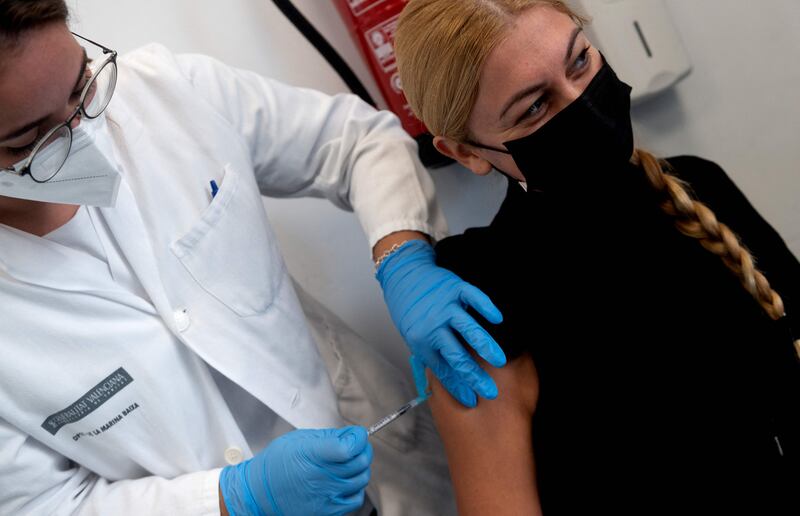 A healthcare worker administers a vaccine during a vaccination campaign for foreign tourists in Benidorm, Spain. AFP