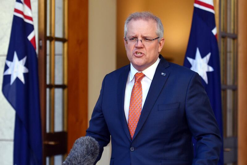 Australian Prime Minister Scott Morrison speaks at a press conference at Parliament House in Canberra, Thursday, July 9, 2020. Australia suspended its extradition treaty with Hong Kong and extended visas for Hong Kong residents in response to China's imposition of a tough national security law on the semi-autonomous territory, the prime minister said. (Mick Tsikas/AAP Image via AP)