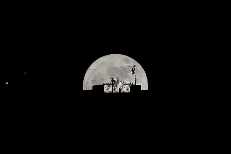 A person walks along the 'Puente Nuevo' (New Bridge) as it is silhouetted against the supermoon during its rise in Ronda, southern Spain. Jon Nazca / Reuters