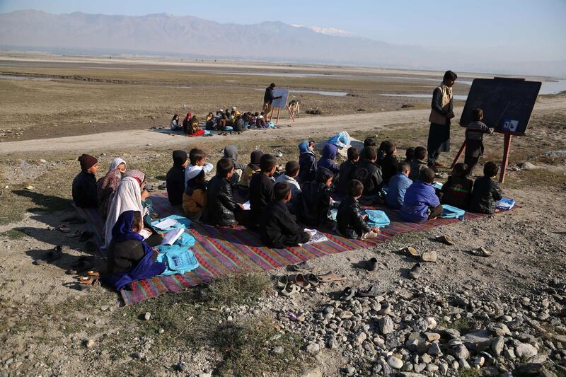 Afghan children take a class in open due to lack of school and facilities in Laghman, Afghanistan. According to reports, 39 per cent of the 9.2 million students in the country are girls. However, three to five million children, mostly girls, are still unable to attend schools.  EPA