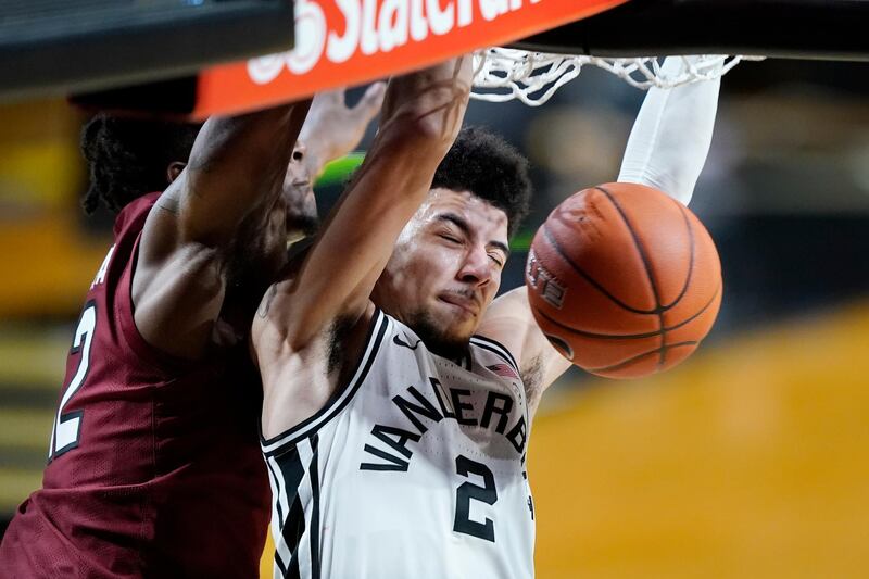 Vanderbilt guard Scotty Pippen Jr. (2) dunks the ball ahead of South Carolina's Trae Hannibal, left, in the first half of an NCAA college basketball game, in Nashville, Tennessee. AP Photo