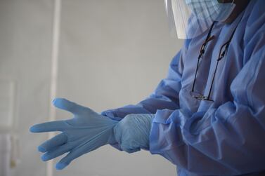 A healthcare worker wearing protective hand gloves. Photographer: I-Hwa Cheng / Bloomberg