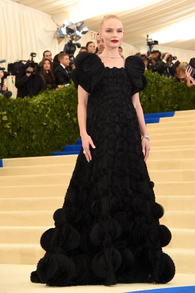 Kate Bosworth sports a voluminous, textured black dress with bold shoulders by Tory Burch. Courtesy of Tory Burch