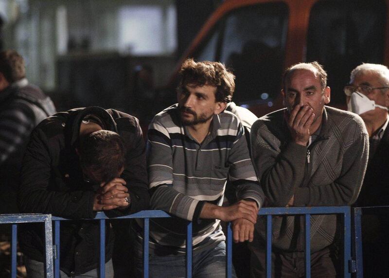 Relatives of miners who are trapped in a coal mine wait in front of the site in Soma. Osman Orsal / Reuters