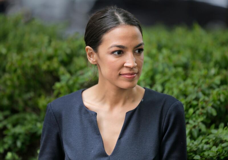 Alexandria Ocasio-Cortez takes a moment between interviews in New York, Wednesday, June 27, 2018. The 28-year-old political newcomer who upset U.S. Rep. Joe Crowley in New York's Democrat primary says she brings an "urgency" to the fight for working families. (AP Photo/Seth Wenig)